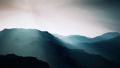 black-rocky-mountain-silhouette-in-deep-fog